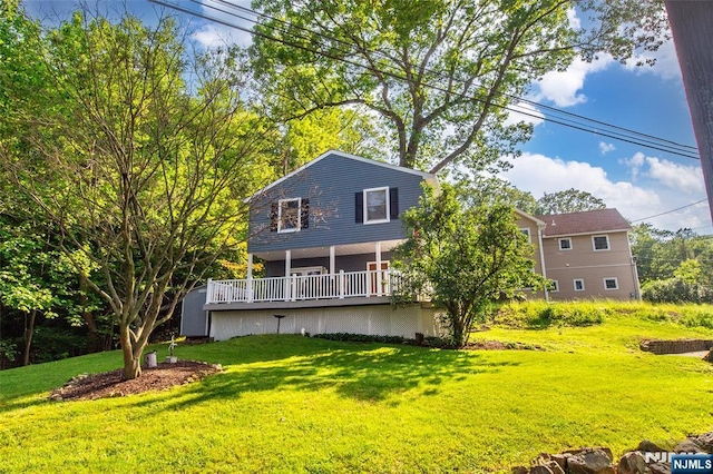 15 Mason St, Jefferson Township, NJ 07849 - rear view of house with a lawn and a deck