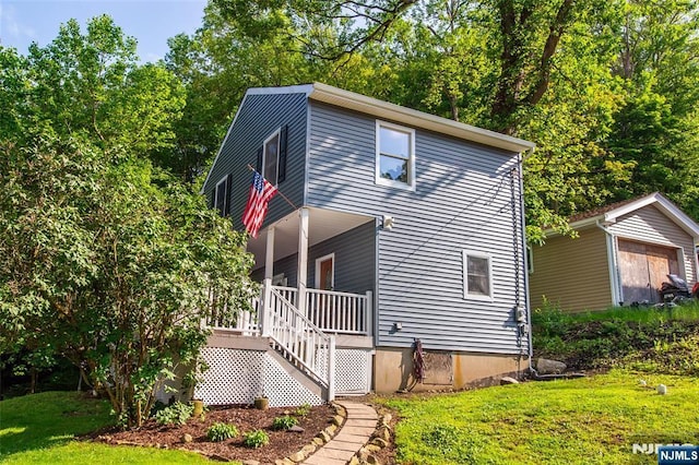 15 Mason St, Jefferson Township, NJ 07849 - view of front of house featuring a front lawn, covered porch, an outdoor structure, and stairs