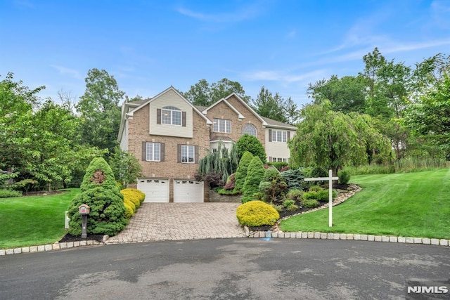 12 Jenny Ln, Wayne, NJ 07470 - view of front of house featuring a garage, driveway, brick siding, and a front yard