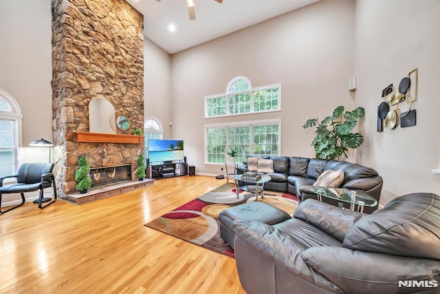 12 Jenny Ln, Wayne, NJ 07470 - living area featuring a high ceiling, a ceiling fan, wood finished floors, a fireplace, and plenty of natural light
