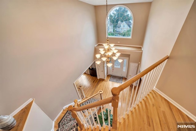 12 Jenny Ln, Wayne, NJ 07470 - staircase with wood finished floors, a high ceiling, and a chandelier