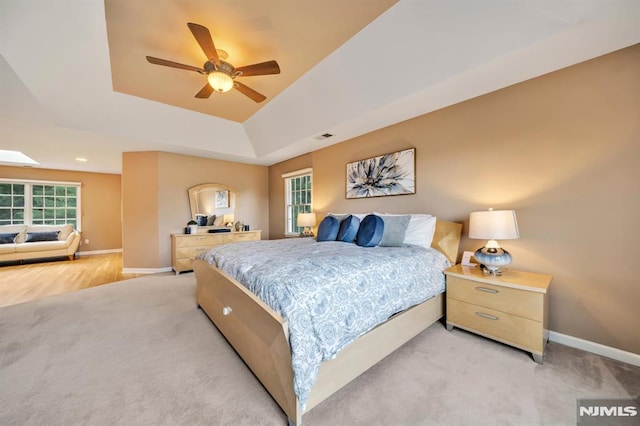 12 Jenny Ln, Wayne, NJ 07470 - bedroom with a tray ceiling, light colored carpet, multiple windows, and a ceiling fan