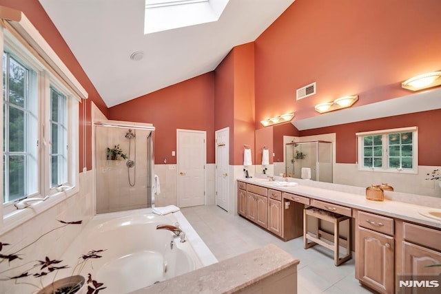 12 Jenny Ln, Wayne, NJ 07470 - bathroom featuring a stall shower, a skylight, a bath, double vanity, and high vaulted ceiling