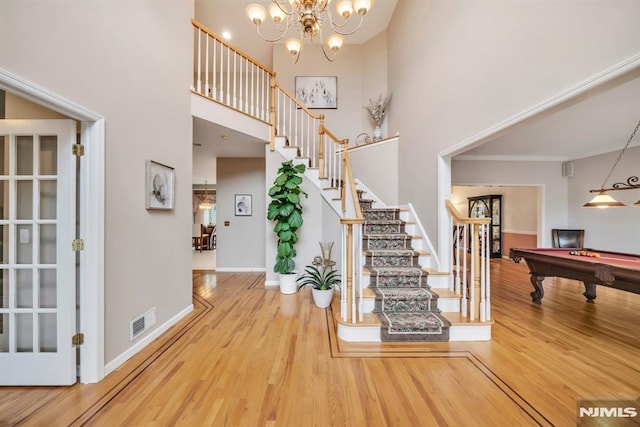 12 Jenny Ln, Wayne, NJ 07470 - stairs with wood finished floors, a high ceiling, billiards table, crown molding, and a chandelier