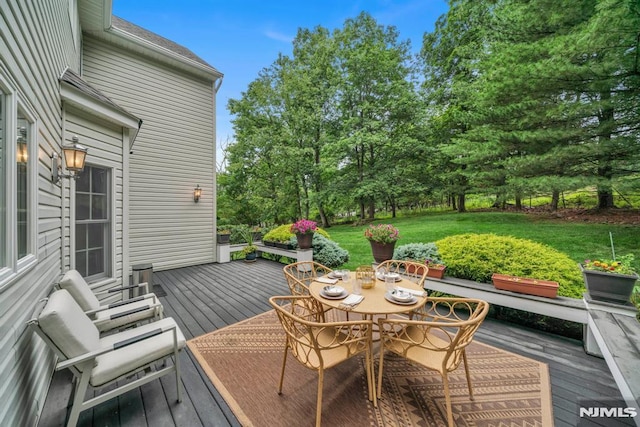 12 Jenny Ln, Wayne, NJ 07470 - wooden terrace with outdoor dining area, a lawn, and view of scattered trees