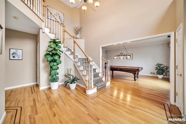 12 Jenny Ln, Wayne, NJ 07470 - entryway with wood finished floors, stairs, a chandelier, pool table, and a high ceiling