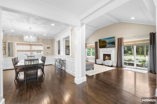 66 Andover Ter, Glen Rock, NJ 07452 - dining space with dark wood-type flooring, a chandelier, a warm lit fireplace, a decorative wall, and a wainscoted wall