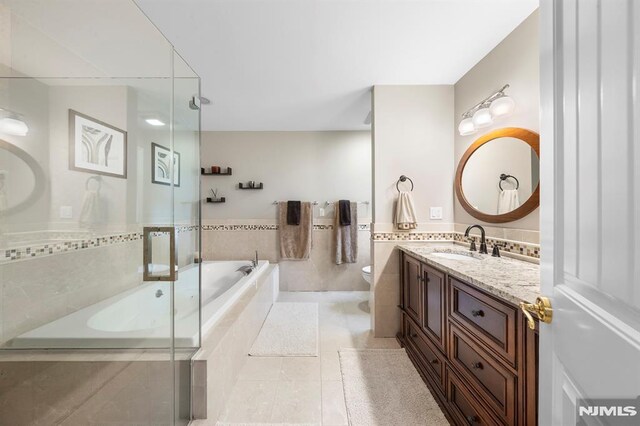 66 Andover Ter, Glen Rock, NJ 07452 - full bathroom with vanity, a garden tub, tile patterned flooring, a shower with shower door, and a wainscoted wall