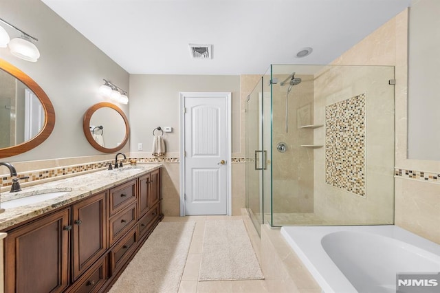 66 Andover Ter, Glen Rock, NJ 07452 - full bath with a garden tub, a stall shower, double vanity, tile walls, and tile patterned flooring