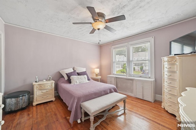 350 Walnut St, Nutley, NJ 07110 - bedroom featuring wood-type flooring, ornamental molding, a ceiling fan, and a textured ceiling