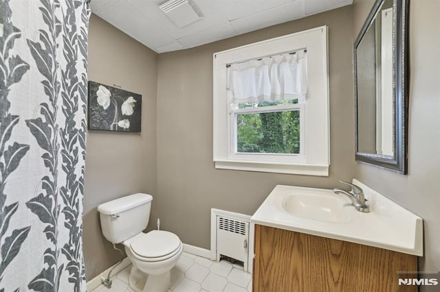 350 Walnut St, Nutley, NJ 07110 - bathroom with radiator heating unit, vanity, and tile patterned floors