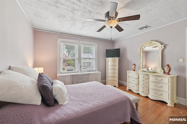 350 Walnut St, Nutley, NJ 07110 - bedroom with light wood-style flooring, a textured ceiling, crown molding, and ceiling fan