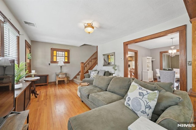 350 Walnut St, Nutley, NJ 07110 - living area featuring stairway, light wood finished floors, and a chandelier