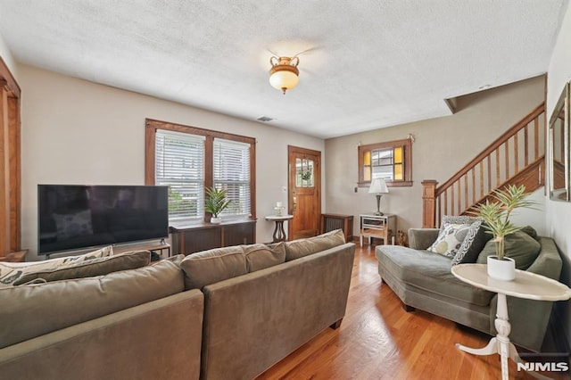 350 Walnut St, Nutley, NJ 07110 - living area with a textured ceiling, stairway, and light wood-style floors