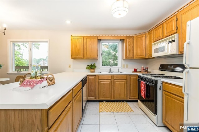 7 Di Donna Ct Unit A007, Clifton, NJ 07013 - kitchen featuring white appliances, light countertops, a peninsula, brown cabinets, and recessed lighting