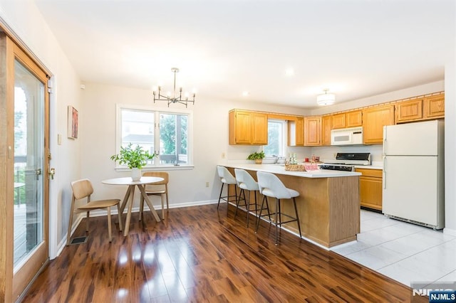 7 Di Donna Ct Unit A007, Clifton, NJ 07013 - kitchen with white appliances, plenty of natural light, a chandelier, light countertops, and recessed lighting
