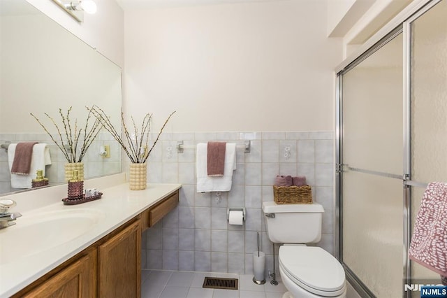 7 Di Donna Ct Unit A007, Clifton, NJ 07013 - bathroom featuring vanity, a stall shower, tile patterned floors, a wainscoted wall, and tile walls