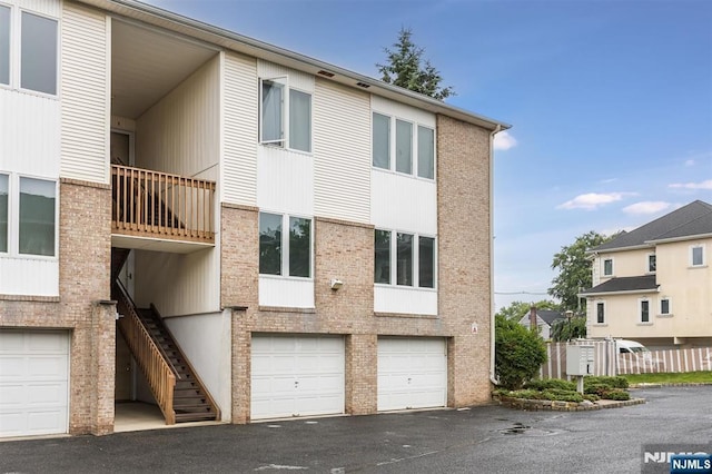 7 Di Donna Ct Unit A007, Clifton, NJ 07013 - view of building exterior with an attached garage, stairway, and driveway