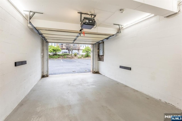 7 Di Donna Ct Unit A007, Clifton, NJ 07013 - garage with a garage door opener, electric panel, and concrete block wall