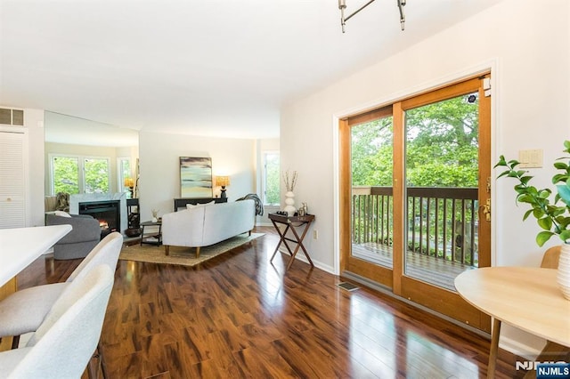 7 Di Donna Ct Unit A007, Clifton, NJ 07013 - living area with healthy amount of natural light, dark wood-style floors, and a lit fireplace