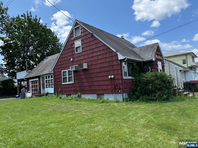 84 Miller Ave, Elmwood Park, NJ 07407 - view of side of home featuring a lawn, a shingled roof, and an AC wall unit