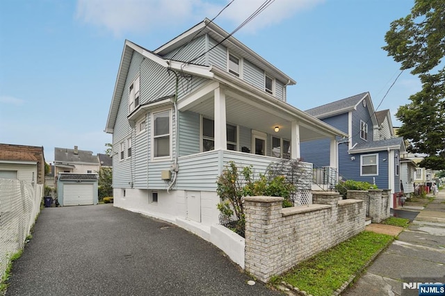 174-176 Albion Ave, Paterson, NJ 07502 - view of front of property featuring covered porch, an outbuilding, and asphalt driveway