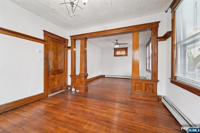174-176 Albion Ave, Paterson, NJ 07502 - spare room with ornate columns, a baseboard heating unit, a baseboard radiator, wood finished floors, and healthy amount of natural light