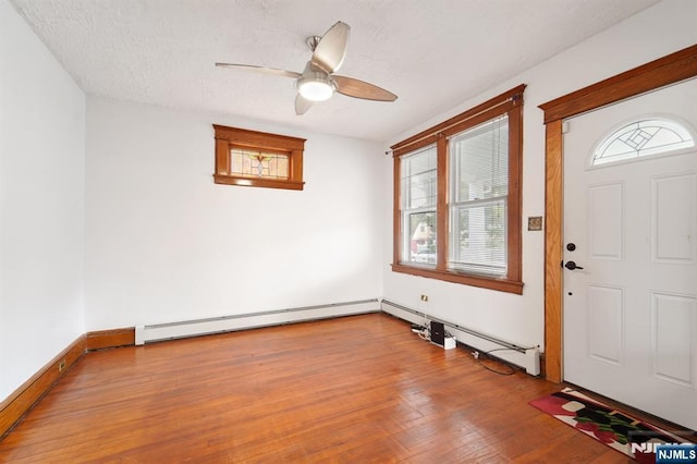 174-176 Albion Ave, Paterson, NJ 07502 - entryway with ceiling fan, wood finished floors, a baseboard radiator, and a textured ceiling
