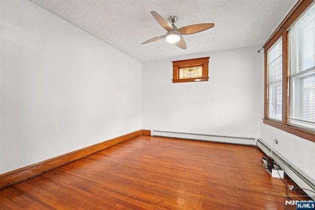 174-176 Albion Ave, Paterson, NJ 07502 - empty room featuring a ceiling fan, wood finished floors, baseboard heating, a textured ceiling, and a baseboard heating unit