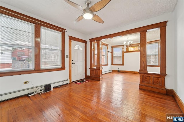 174-176 Albion Ave, Paterson, NJ 07502 - entryway featuring ornate columns, baseboard heating, a chandelier, ceiling fan, and hardwood / wood-style flooring