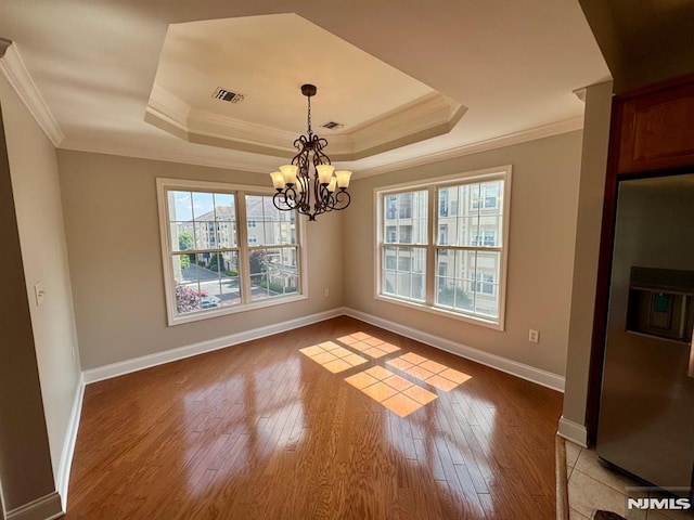 7207 Ravenscroft Rd Unit 7207, Clifton, NJ 07013 - unfurnished dining area with crown molding, a tray ceiling, light wood-style floors, and a chandelier