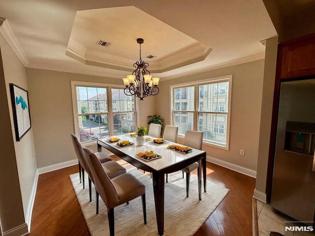 7207 Ravenscroft Rd Unit 7207, Clifton, NJ 07013 - dining space featuring a raised ceiling, healthy amount of natural light, crown molding, a chandelier, and light wood-style flooring