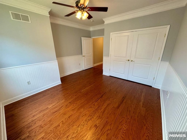 7207 Ravenscroft Rd Unit 7207, Clifton, NJ 07013 - unfurnished bedroom featuring ornamental molding, a wainscoted wall, wood finished floors, a closet, and ceiling fan