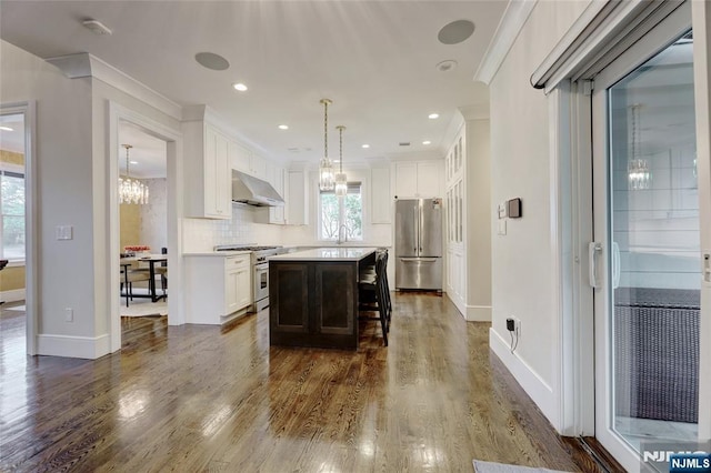 62 Merritt Ave, Cresskill, NJ 07626 - kitchen featuring appliances with stainless steel finishes, a chandelier, under cabinet range hood, crown molding, and white cabinets