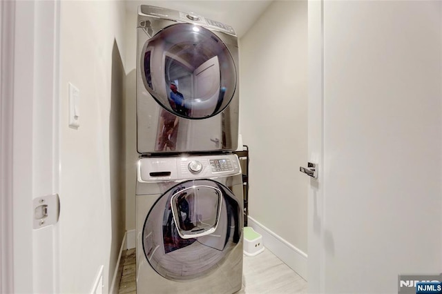 62 Merritt Ave, Cresskill, NJ 07626 - laundry room with stacked washing machine and dryer and wood finished floors