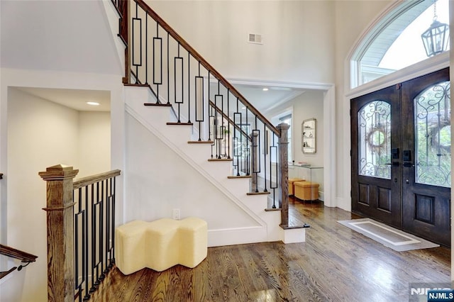 62 Merritt Ave, Cresskill, NJ 07626 - entrance foyer with wood finished floors, a towering ceiling, french doors, and stairs