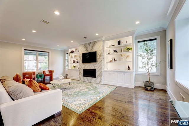 62 Merritt Ave, Cresskill, NJ 07626 - living area with crown molding, dark wood-style floors, recessed lighting, a fireplace, and built in features