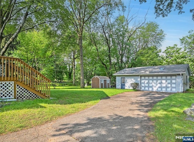 126 Grant Ave, Cresskill, NJ 07626 - view of grassy yard featuring a storage shed, stairs, view of wooded area, and a garage
