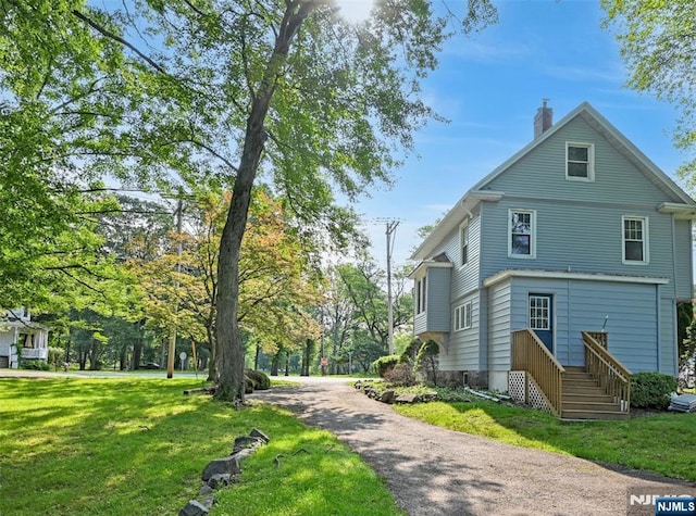 126 Grant Ave, Cresskill, NJ 07626 - view of home's exterior featuring a chimney and a lawn