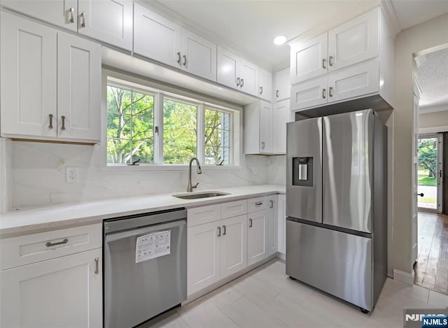 126 Grant Ave, Cresskill, NJ 07626 - kitchen with stainless steel appliances, white cabinets, backsplash, light stone countertops, and recessed lighting