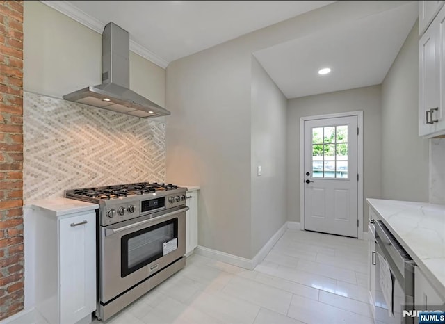 126 Grant Ave, Cresskill, NJ 07626 - kitchen with stainless steel appliances, wall chimney range hood, light stone countertops, backsplash, and white cabinetry