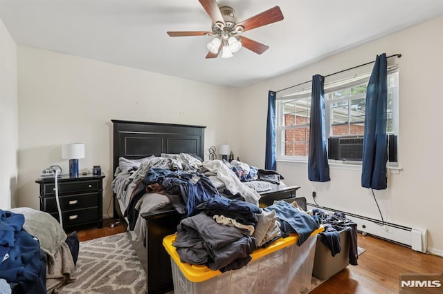 1245 Valley Rd Unit B, Wayne, NJ 07470 - bedroom featuring baseboard heating, wood finished floors, cooling unit, and ceiling fan