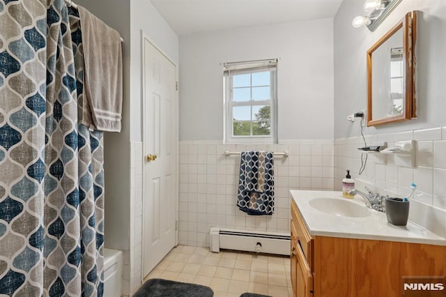 1245 Valley Rd Unit B, Wayne, NJ 07470 - bathroom featuring a baseboard heating unit, tile patterned floors, vanity, tile walls, and a wainscoted wall
