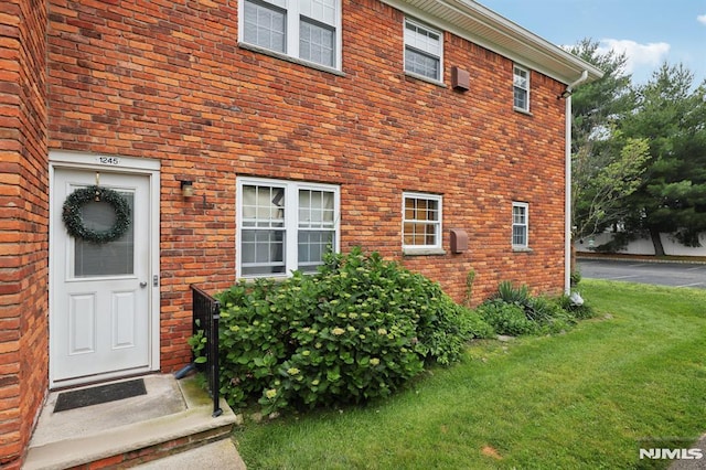 1245 Valley Rd Unit B, Wayne, NJ 07470 - doorway to property with a yard and brick siding