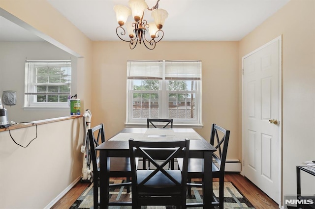 1245 Valley Rd Unit B, Wayne, NJ 07470 - dining area featuring wood finished floors, a chandelier, and a baseboard heating unit