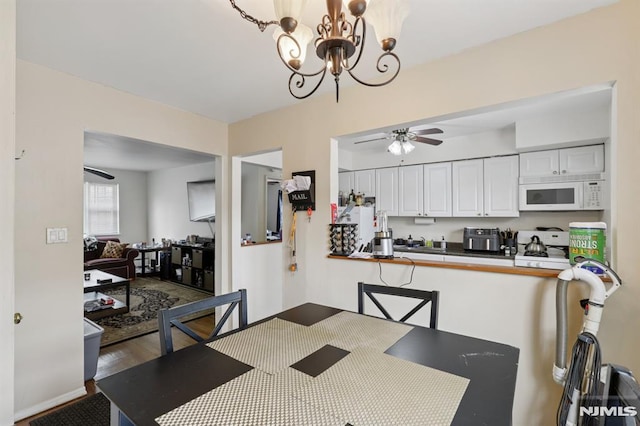 1245 Valley Rd Unit B, Wayne, NJ 07470 - dining area featuring a ceiling fan, wood finished floors, and a chandelier