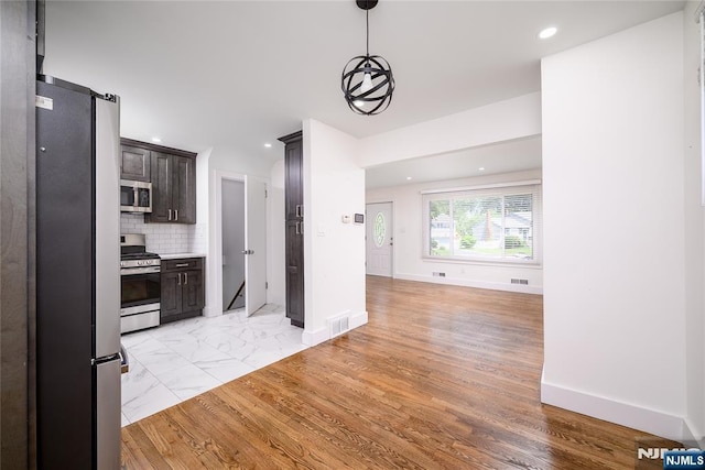 69 Lorraine Dr, Clifton, NJ 07012 - kitchen with appliances with stainless steel finishes, dark brown cabinetry, recessed lighting, open floor plan, and decorative backsplash