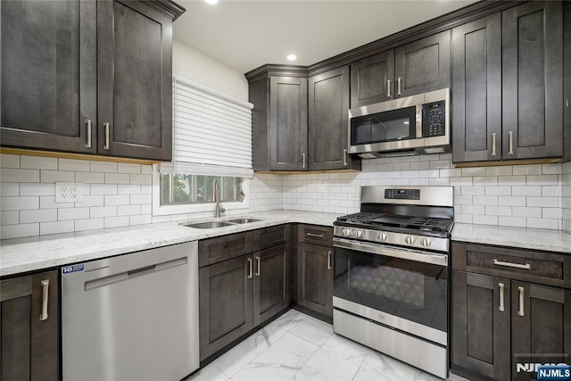 69 Lorraine Dr, Clifton, NJ 07012 - kitchen with appliances with stainless steel finishes, light marble finish floors, light stone counters, dark brown cabinetry, and recessed lighting