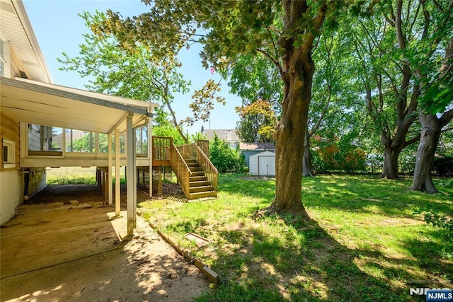69 Lorraine Dr, Clifton, NJ 07012 - view of grassy yard with stairway, a shed, and a wooden deck