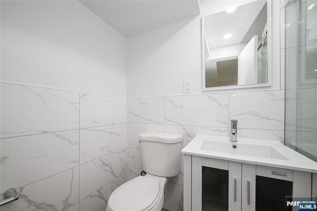 69 Lorraine Dr, Clifton, NJ 07012 - bathroom featuring vanity, tile walls, and wainscoting
